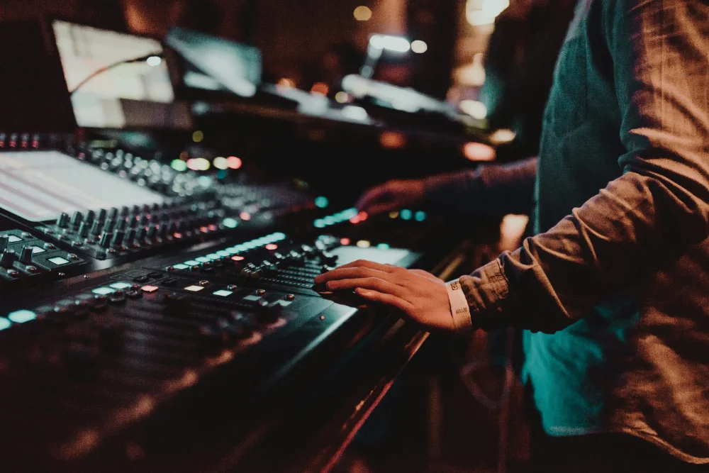 audio engineer recording on an audio console